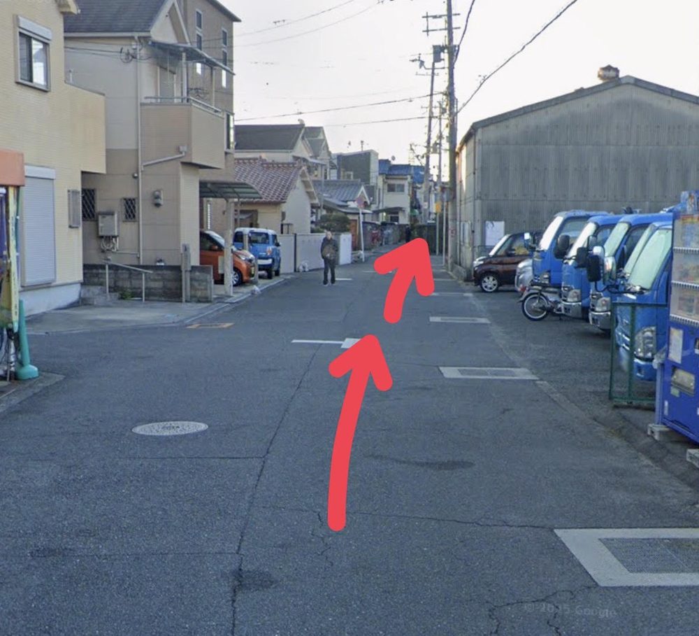 自動販売機のある通りを、矢印にそって奥へ進む地点の写真